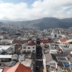 Colonial Rooftops and Mountain Horizon – Aerial View of Historic City