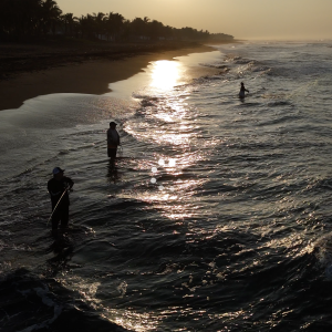Sunrise Shoreline – Early Morning Fishermen in Silhouette