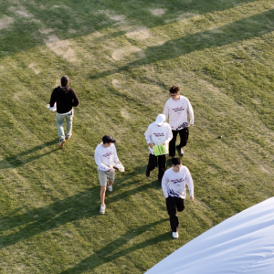 Team Briefing – Aerial View of Group on Sports Field (Copy)